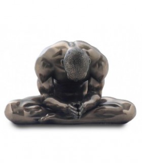 Statue of a naked bodybuilder meditating. - 19976